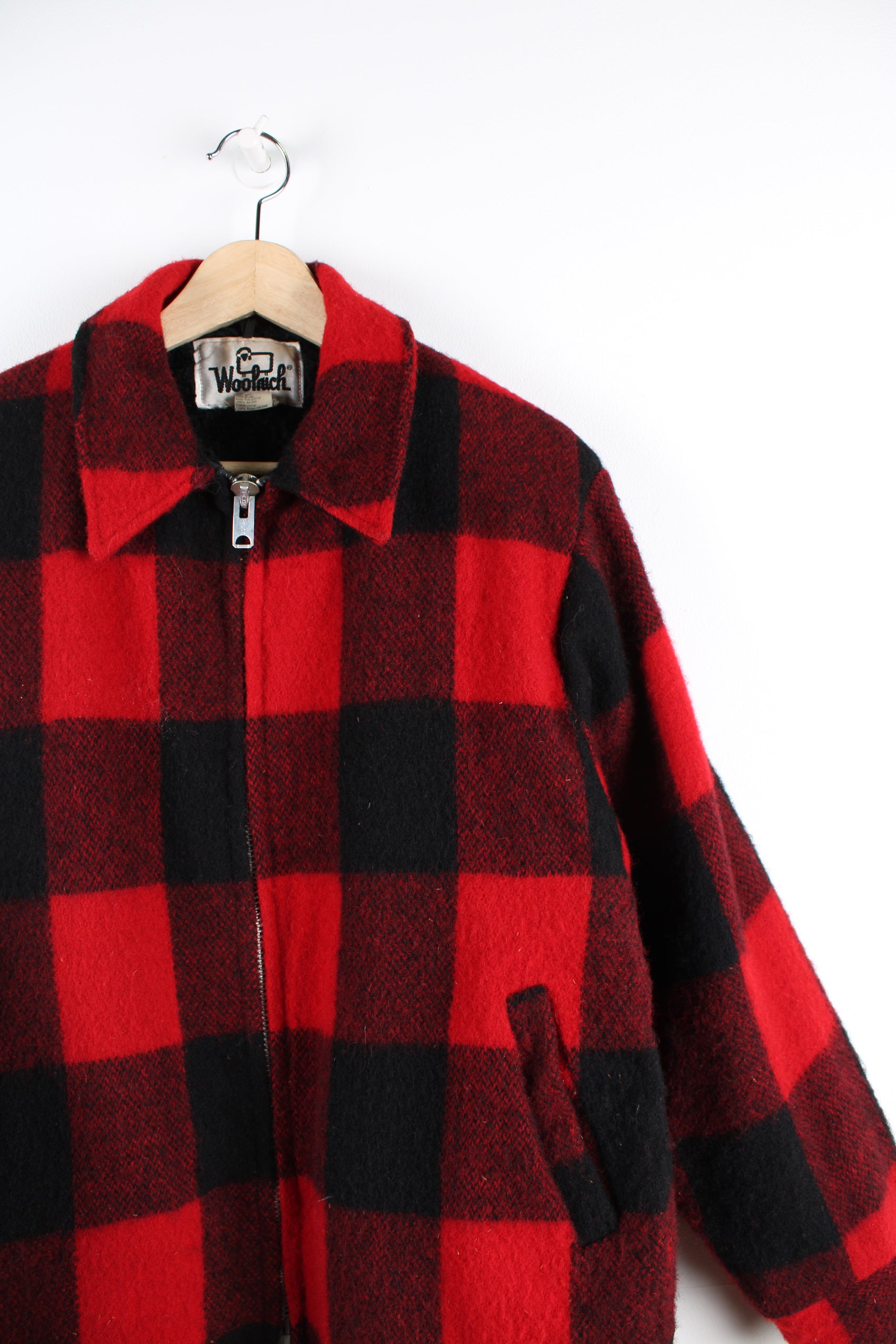 Vintage Woolrich red & black plaid wool CPO jacket, zip up with side pockets and fleece lining.