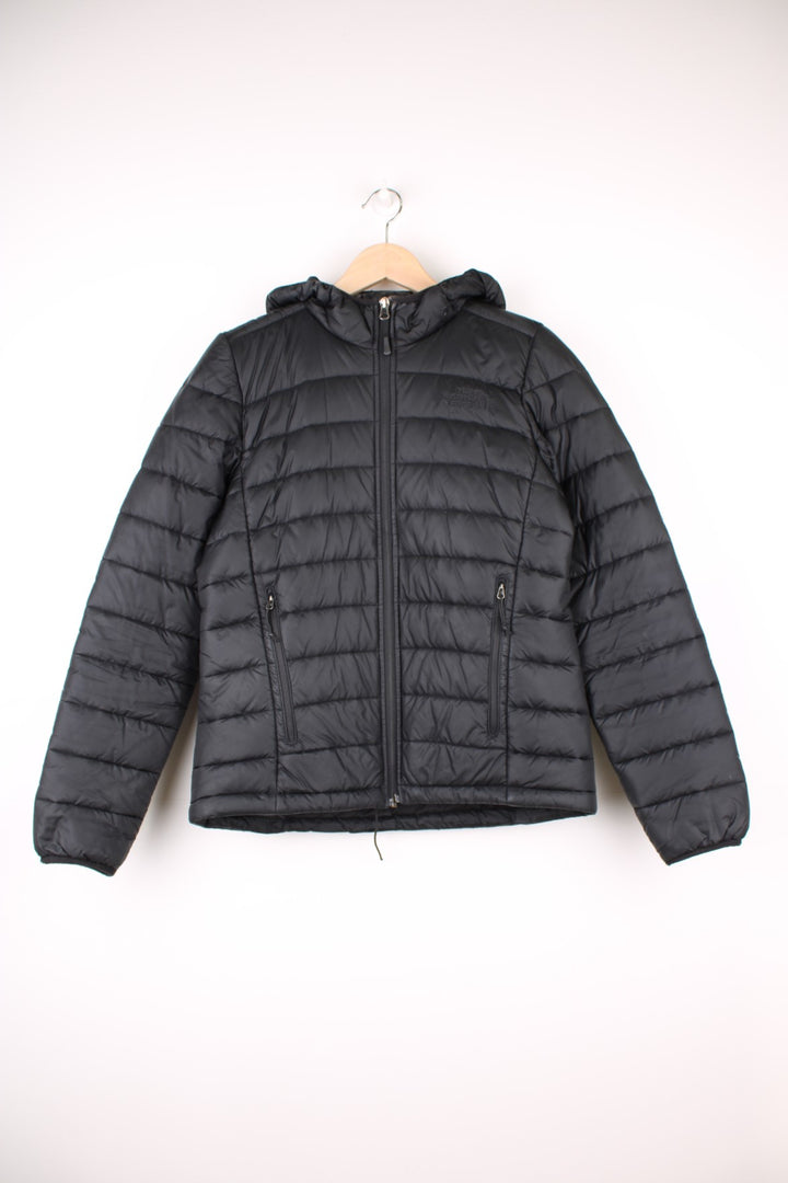 The North Face Puffer Jacket in a black colourway, zip up with side pockets, insulated, hooded, and has the logo embroidered on the front and back.