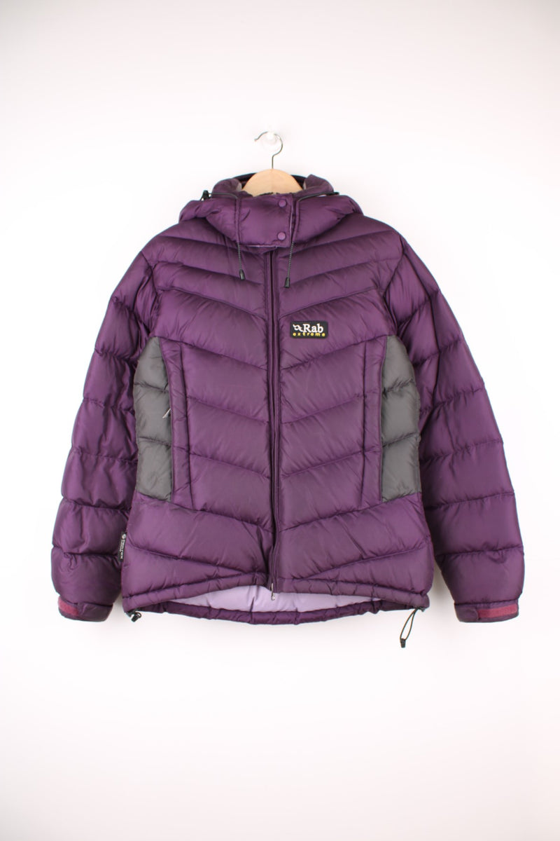 Rab Extreme Puffer Jacket in a purple colourway, zip up with side pockets, has a detachable hood, insulated, and has the logo embroidered on the front.