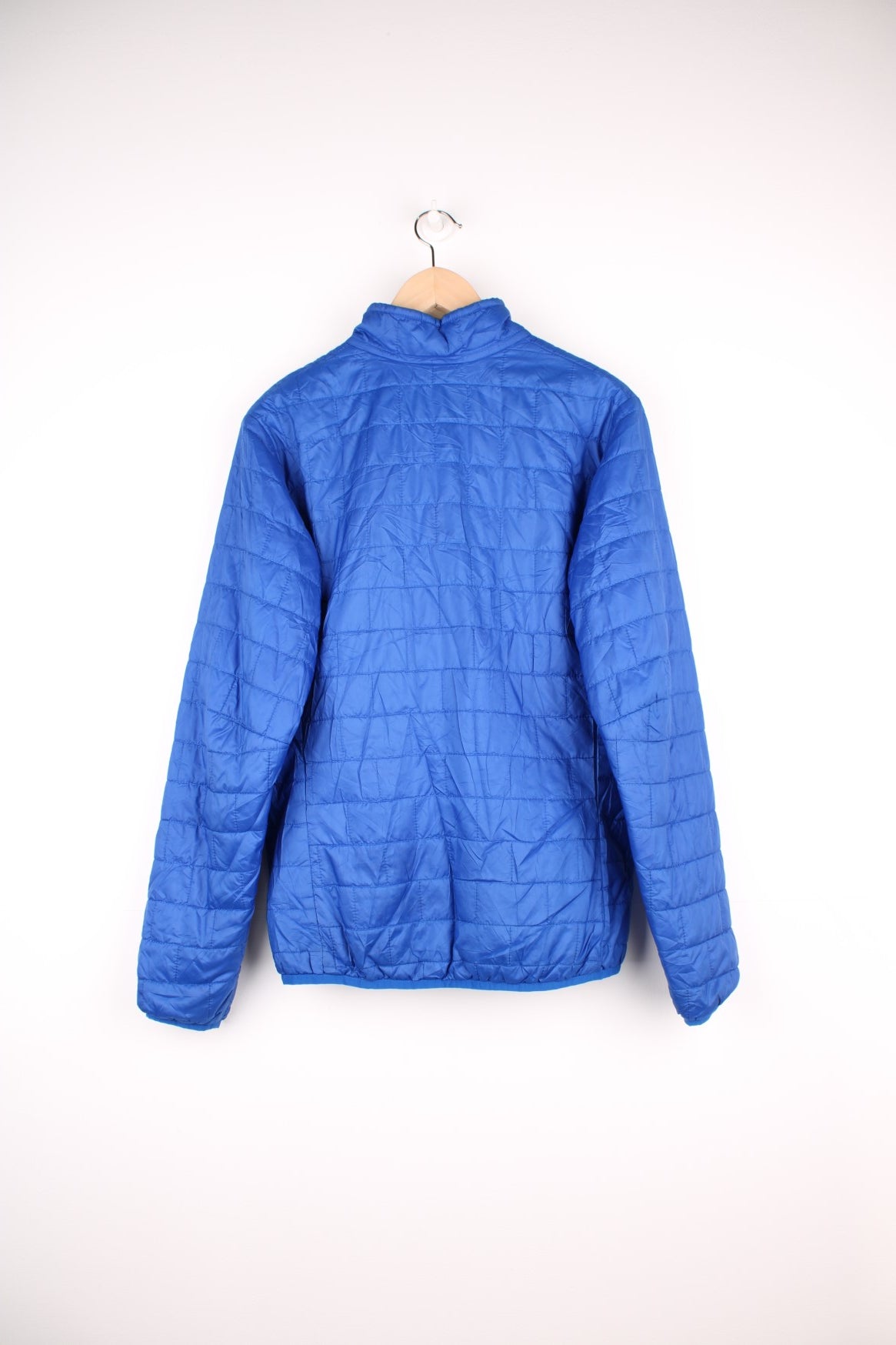 Patagonia Pullover Puffer Jacket in a blue colourway, half zip up with only one pocket on the chest, insulated, and has the logo embroidered on the front.