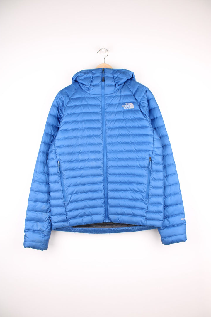 The North Face Puffer Jacket in a blue colourway, zip up with side pockets, hooded and has the logo embroidered on the front and back.