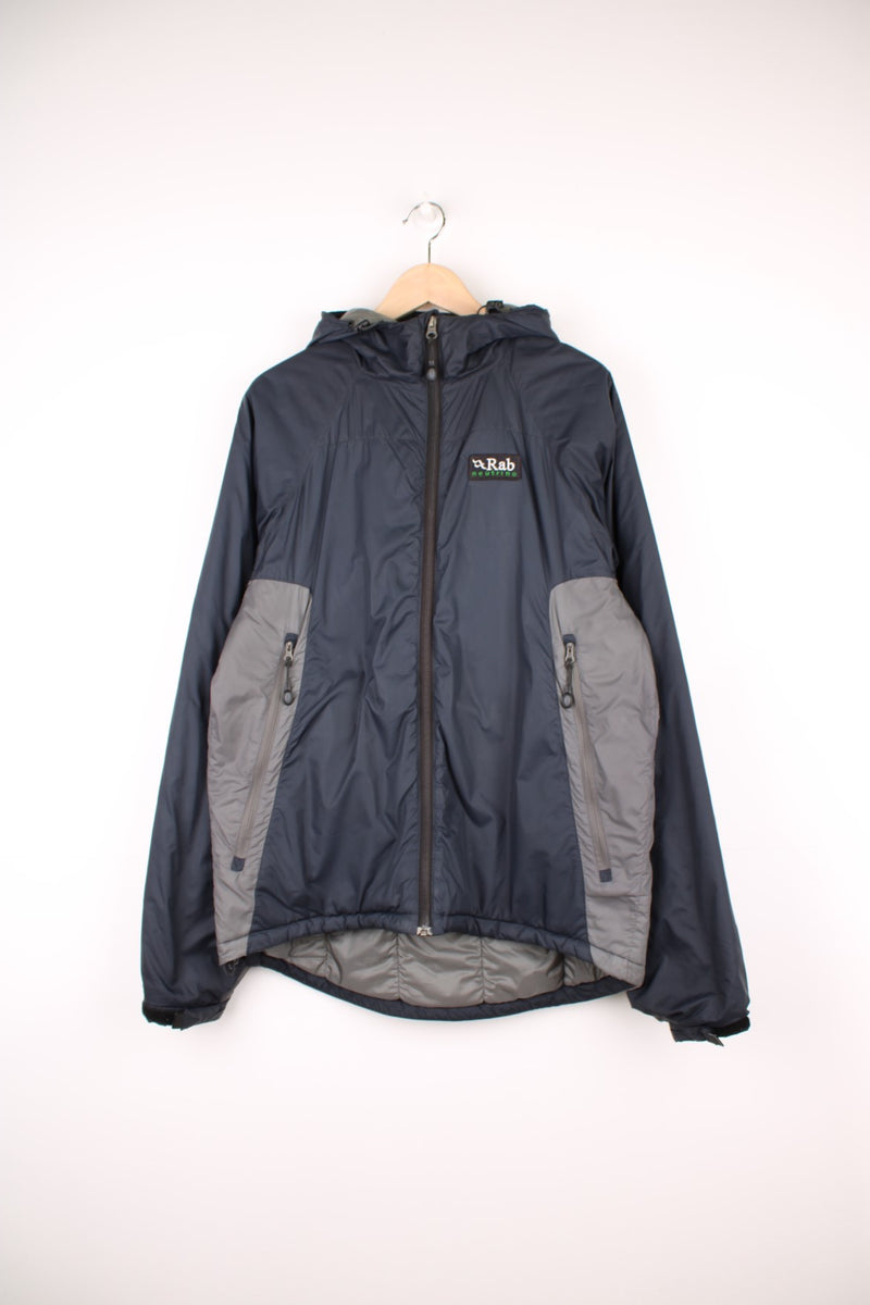 Rab Neutrino Jacket in a black and grey colourway, zip up with side pockets, insulated, hooded and has the logo embroidered on the front.