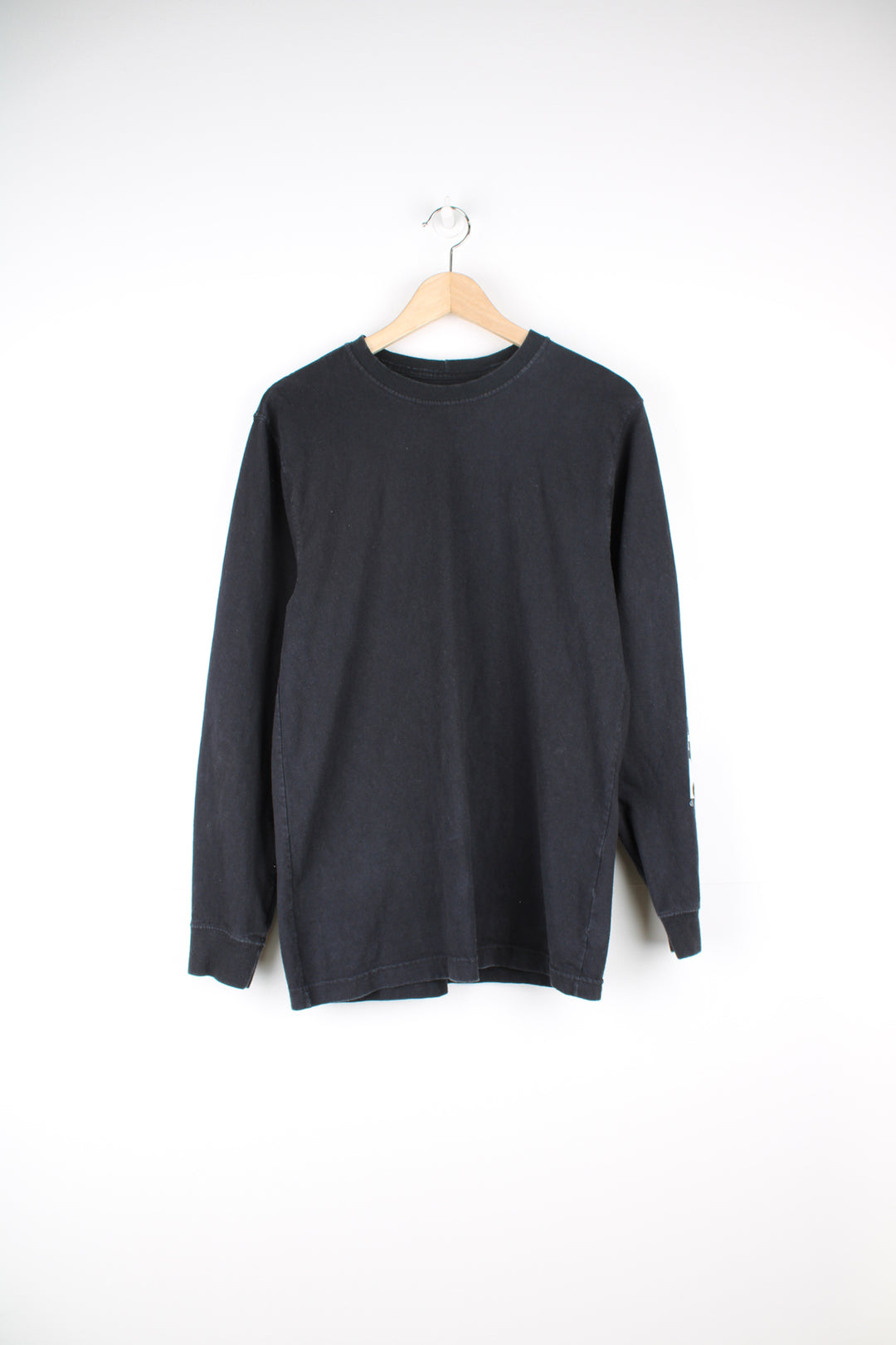 Carhartt Long Sleeve T-Shirt in a black colourway with white printed Carhartt spell out going down the left sleeve.