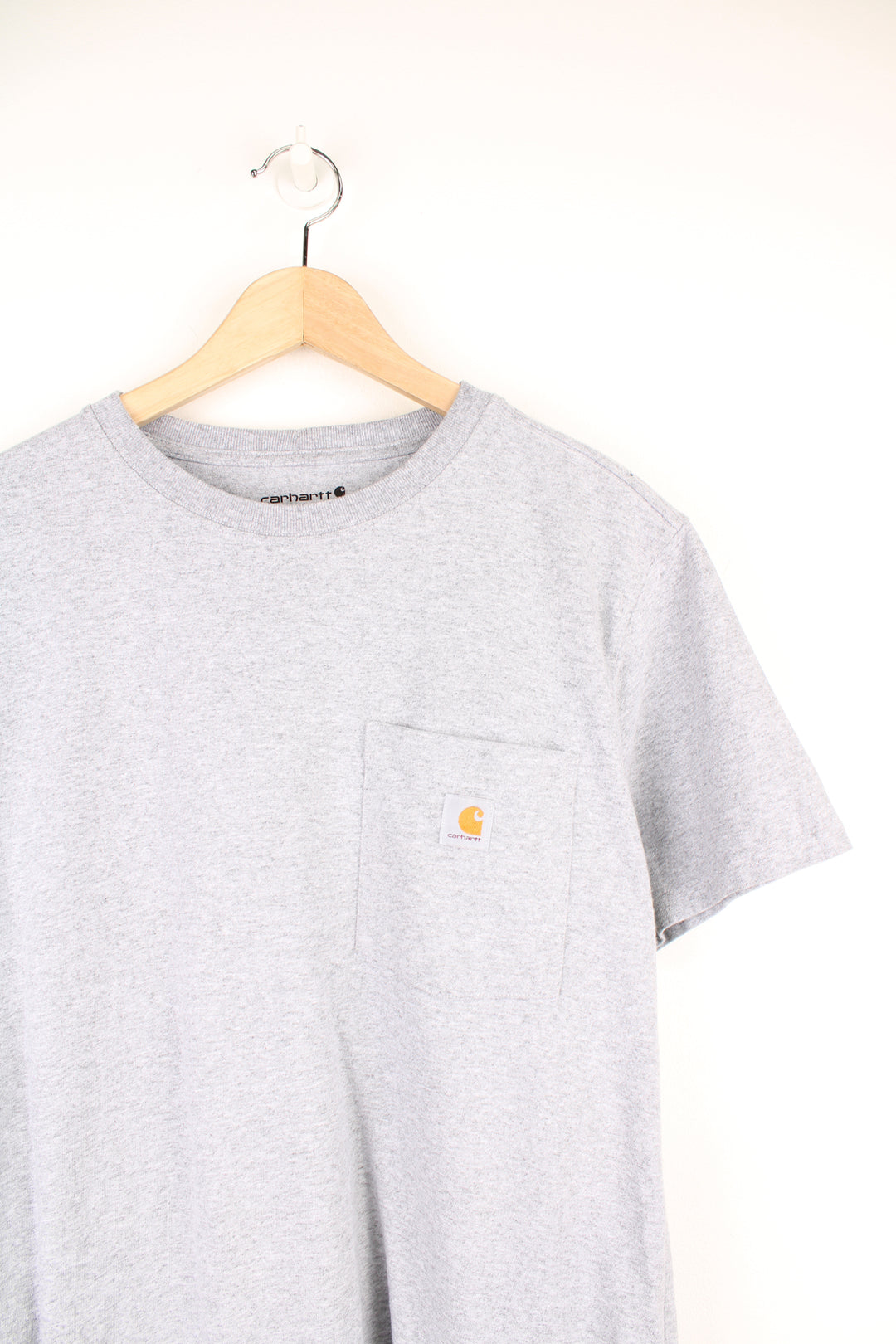 Carhartt T-Shirt in a grey colourway, has a chest pocket with the logo embroidered on it.