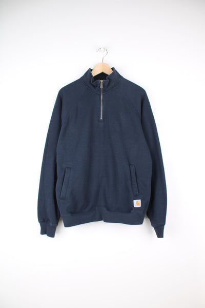 Carhartt Quarter Zip Sweatshirt in a blue colourway with side pockets, and has the logo embroidered on the front.