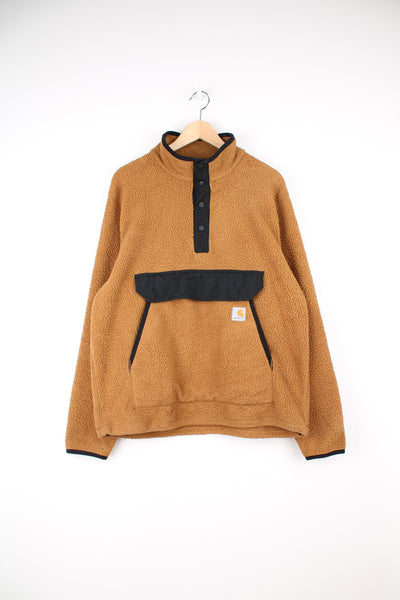 Carhartt Pullover Fleece in a brown colourway, button up with big pouch pockets, and has the logo embroidered on the front.