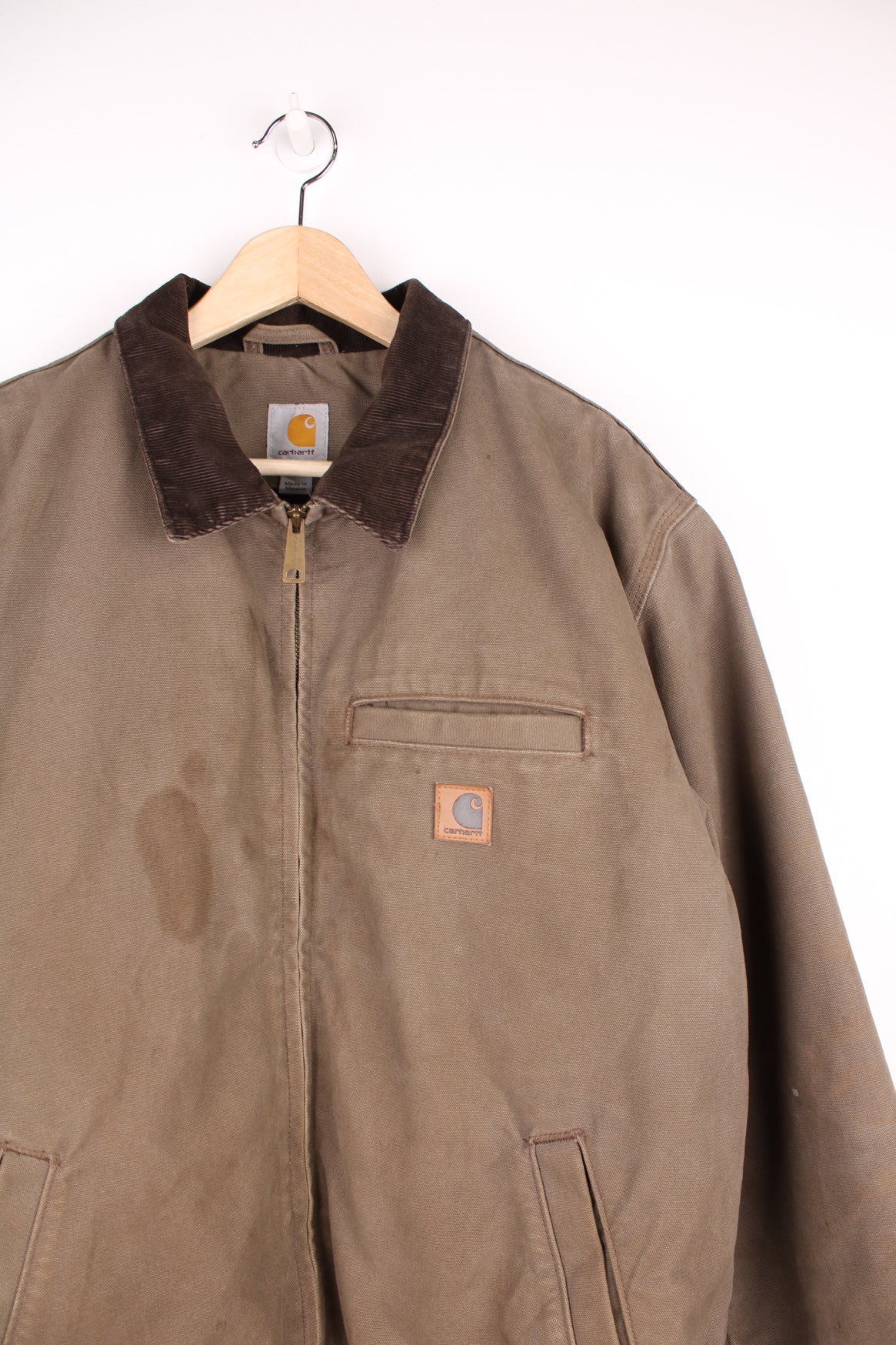 Carhartt Detroit Jacket in a brown colourway with a corduroy collar, zip up, multiple pockets, and has the logo embroidered on the front.