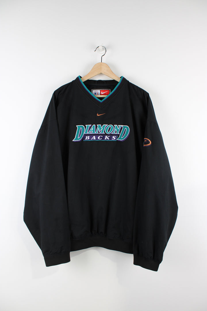 Vintage Nike Diamond Backs MLB training top in black, v neck with two side pockets, has centre swoosh and Diamond Backs spell-out on the front.