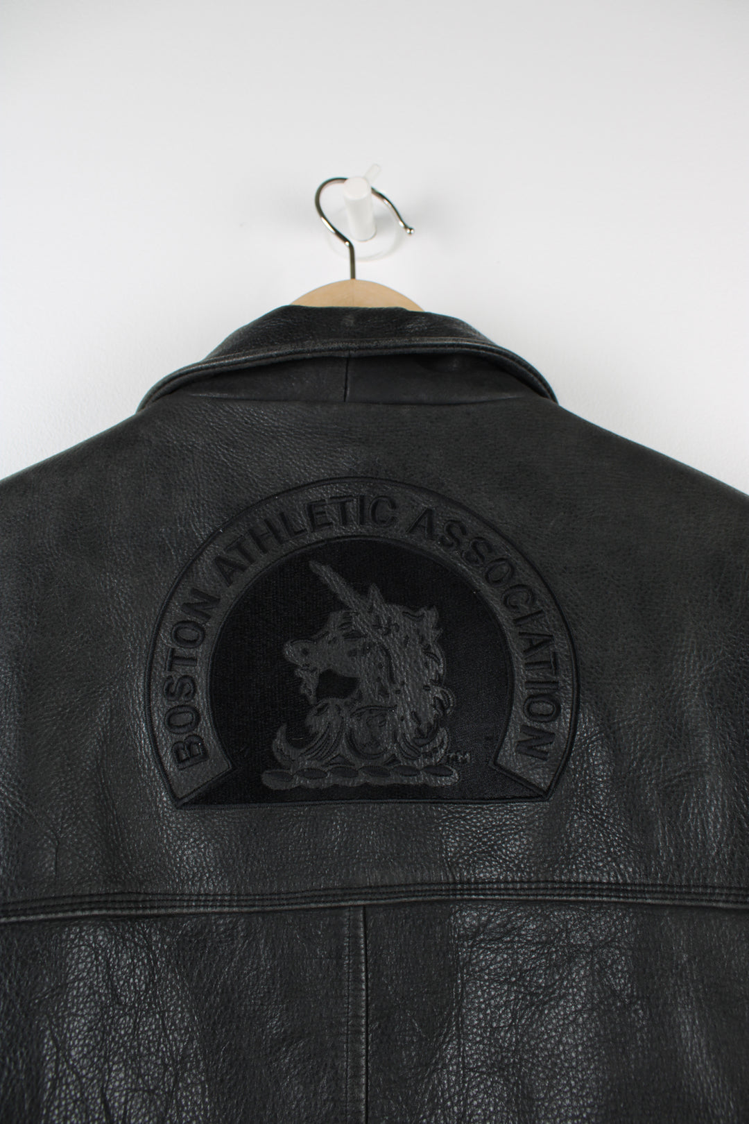 Vintage Adidas Boston Athletic Association leather jacket in black, zip up with two side pockets, has a quilted lining and embroidered logos on the sleeve and back of the jacket.