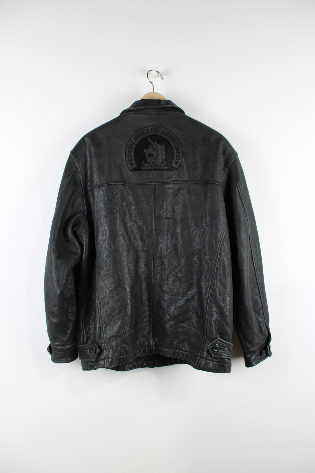 Vintage Adidas Boston Athletic Association leather jacket in black, zip up with two side pockets, has a quilted lining and embroidered logos on the sleeve and back of the jacket.