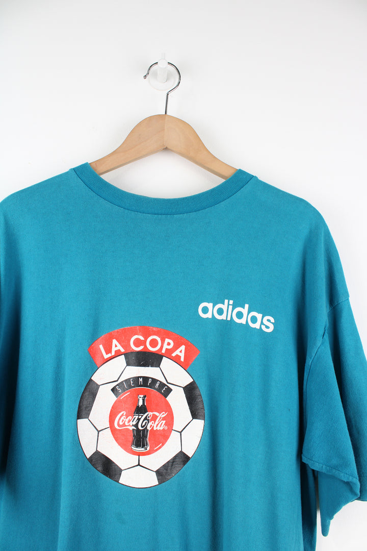 Vintage 90's Adidas, Coca Cola Single Stitch T-Shirt in a blue colourway, football graphic printed on the front alongside the Adidas logo, and number 18 printed on the back.