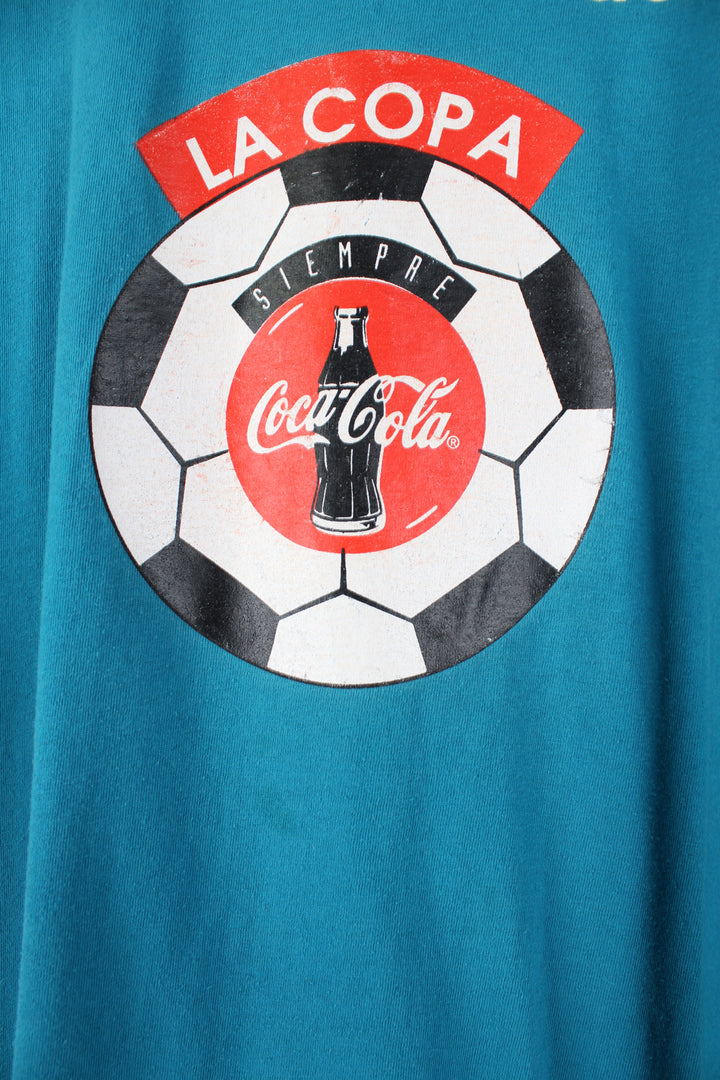 Vintage 90's Adidas, Coca Cola Single Stitch T-Shirt in a blue colourway, football graphic printed on the front alongside the Adidas logo, and number 18 printed on the back.