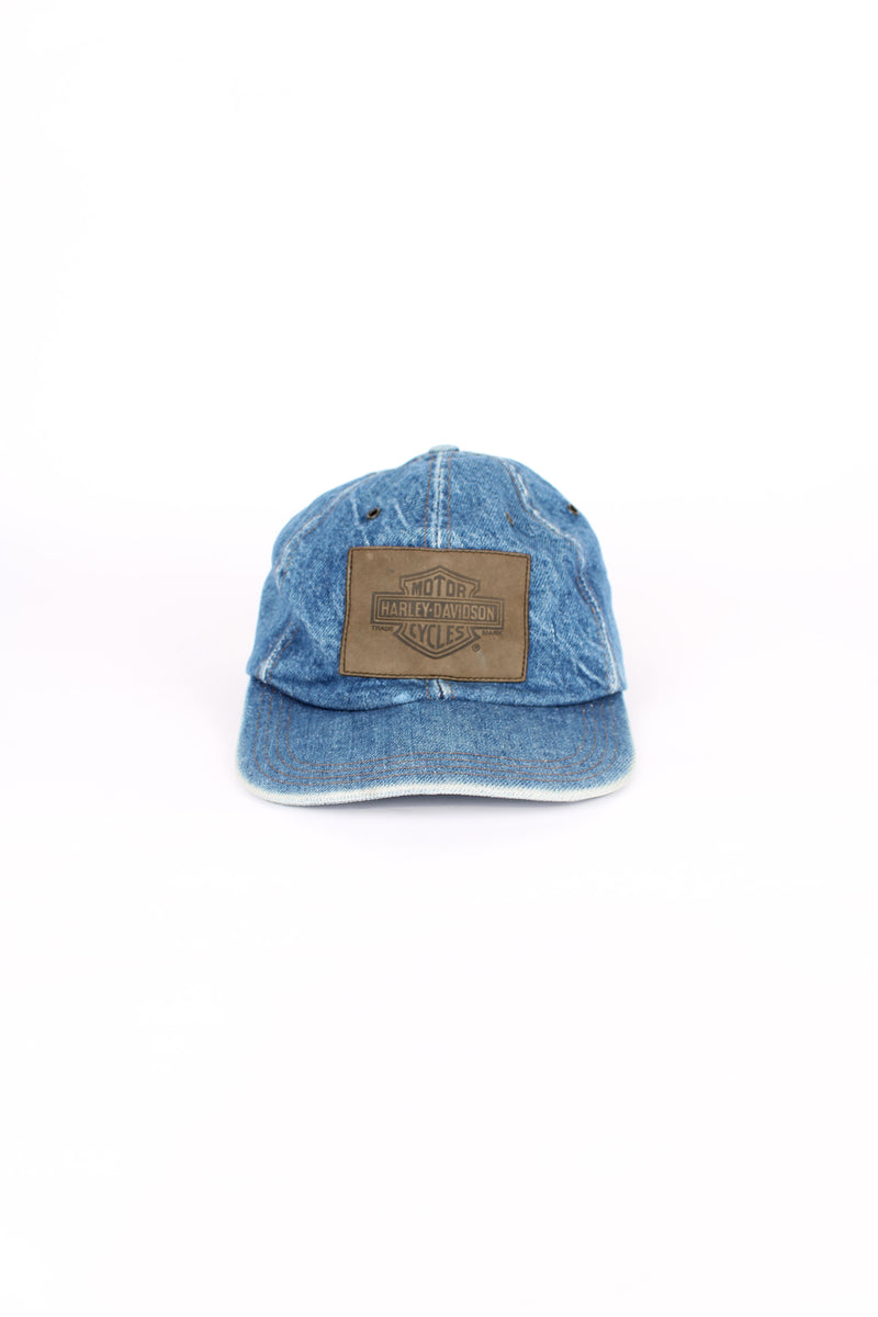 Vintage Harley Davidson denim blue cap, 100% cotton, made in USA, eyelet holes around the top, embroidered badge logo on the front and has an adjustable strap. 