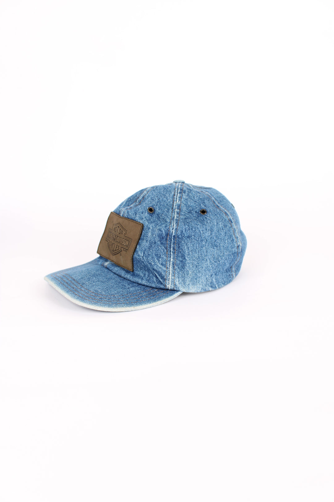 Vintage Harley Davidson denim blue cap, 100% cotton, made in USA, eyelet holes around the top, embroidered badge logo on the front and has an adjustable strap. 