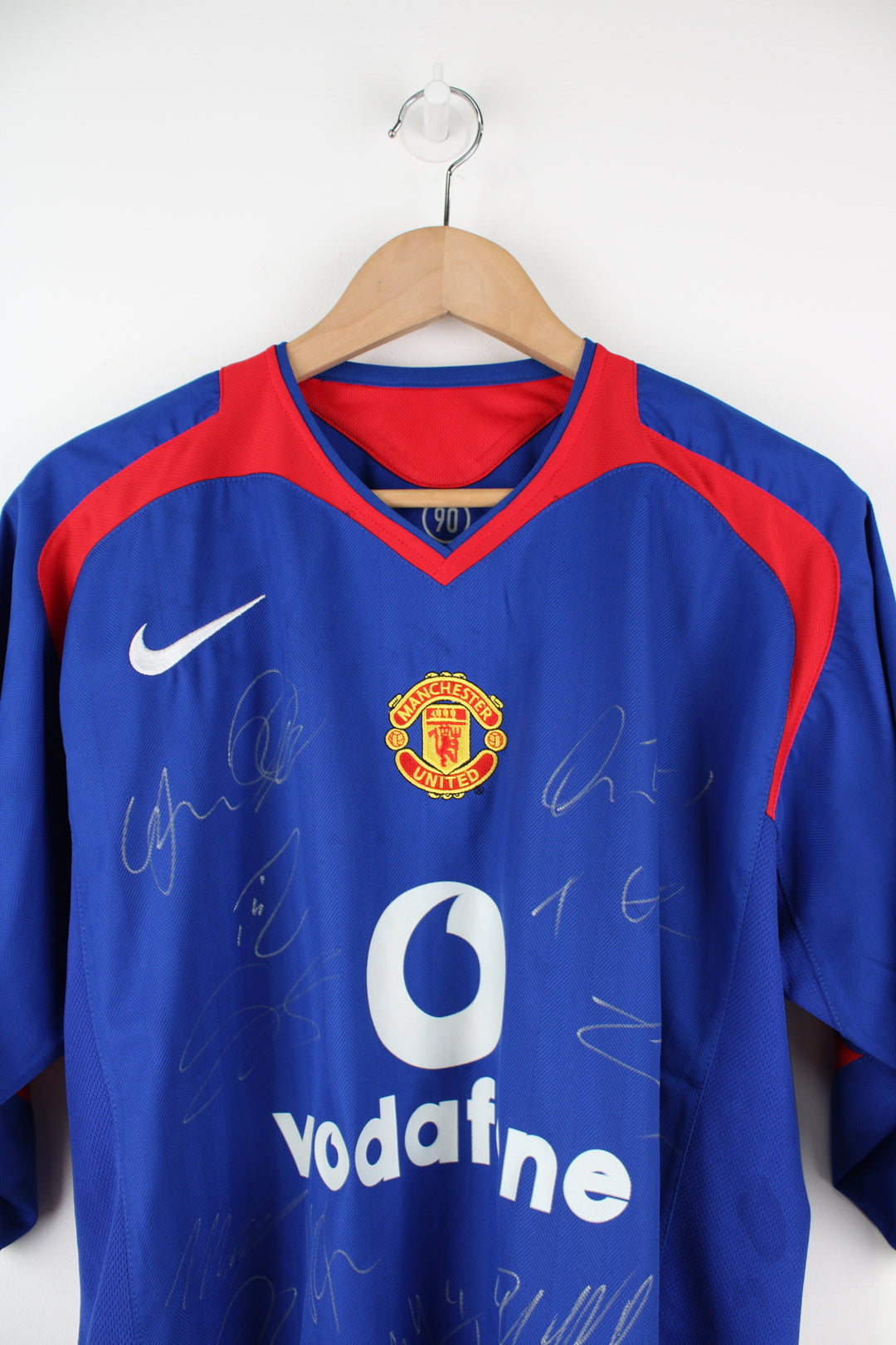 Manchester United 2005/06, Nike Football Kit in a blue, white and red colourway, signed by the players, V-neck and has logos printed on the front.