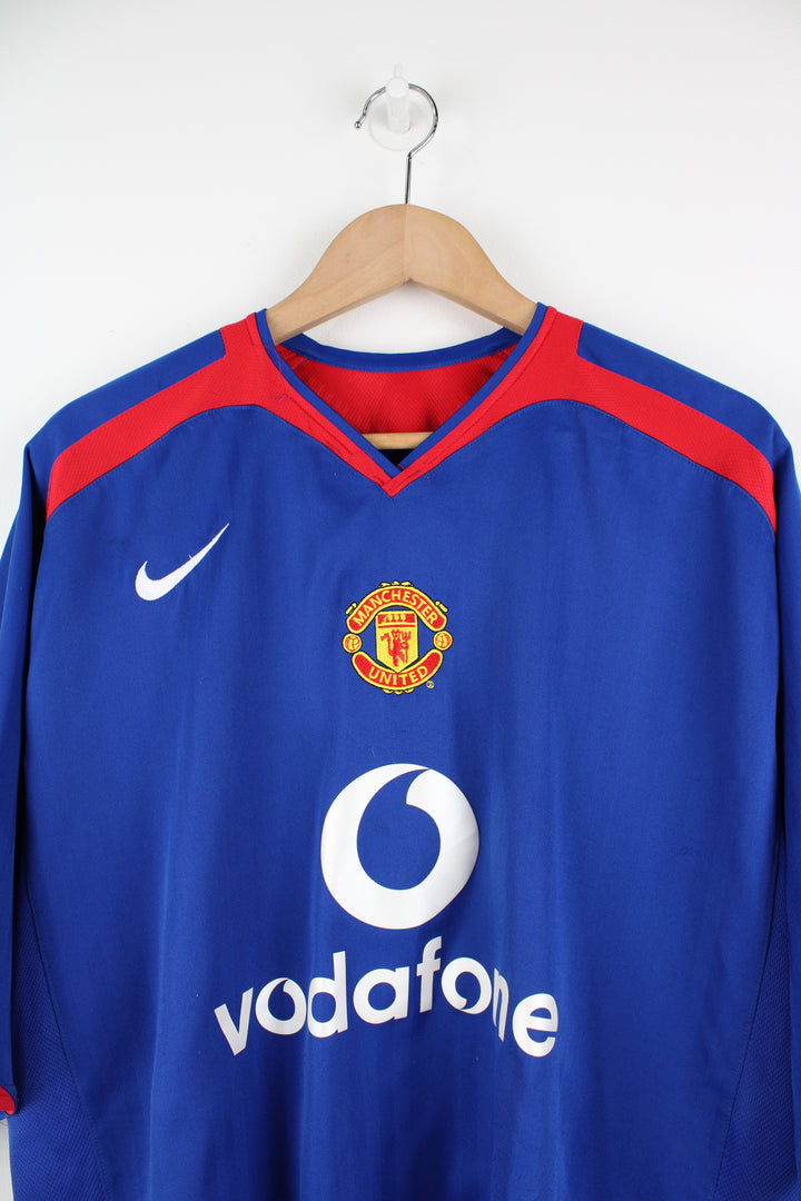 Manchester United 2005/06, Nike Football Kit in a blue, white and red colourway, V-neck and has logos embroidered on the front.