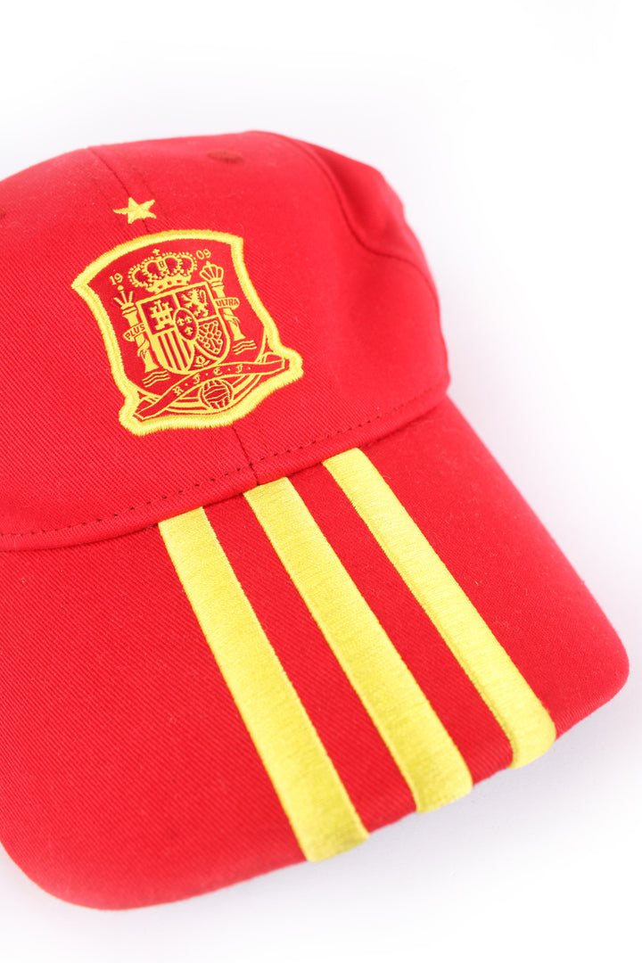 Adidas Football, Spain cap in red and yellow country colours but blue under the peak, 100% cotton, Spain football flag embroidered on the front, and has Adidas stripes as well.