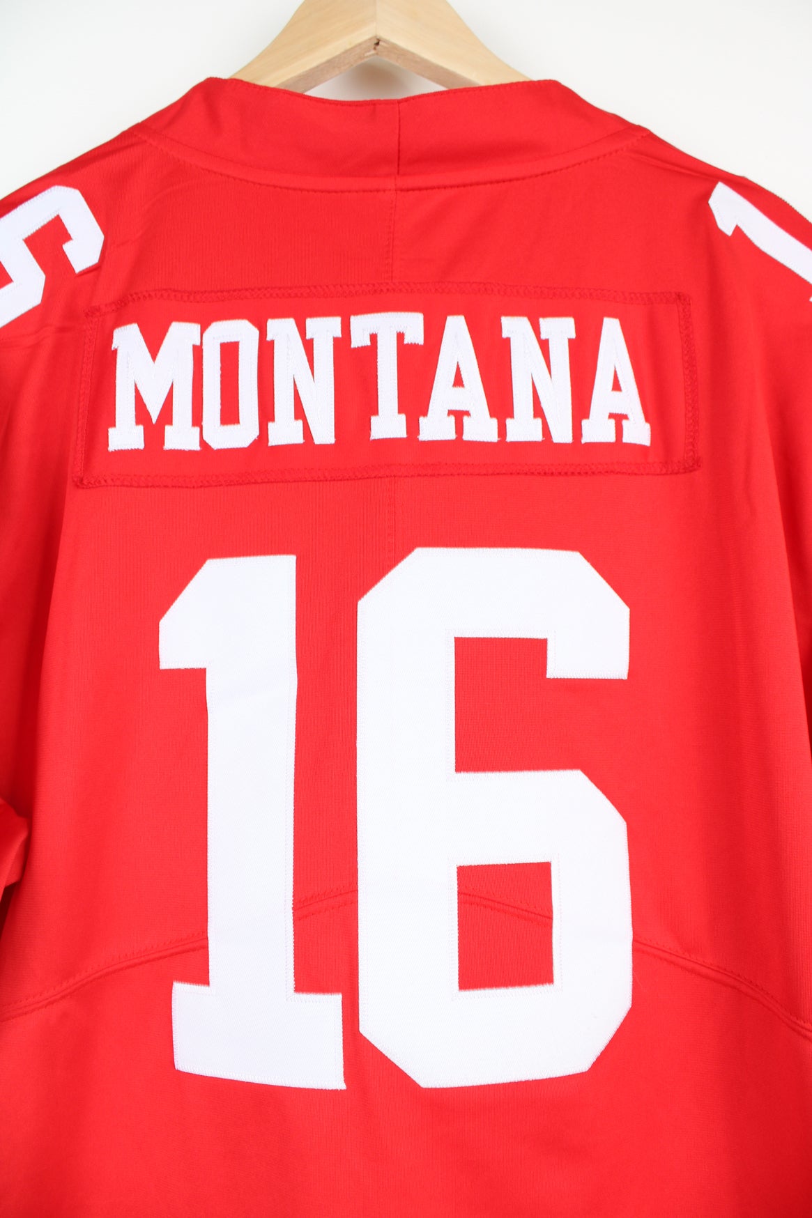 All red San Francisco 49ERS NFL jersey, by Nike. with embroidered name on the back Joe Montana 