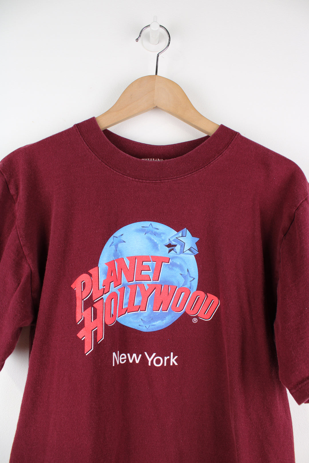 Planet Hollywood New York t-shirt in maroon, features spell-out graphic on the front