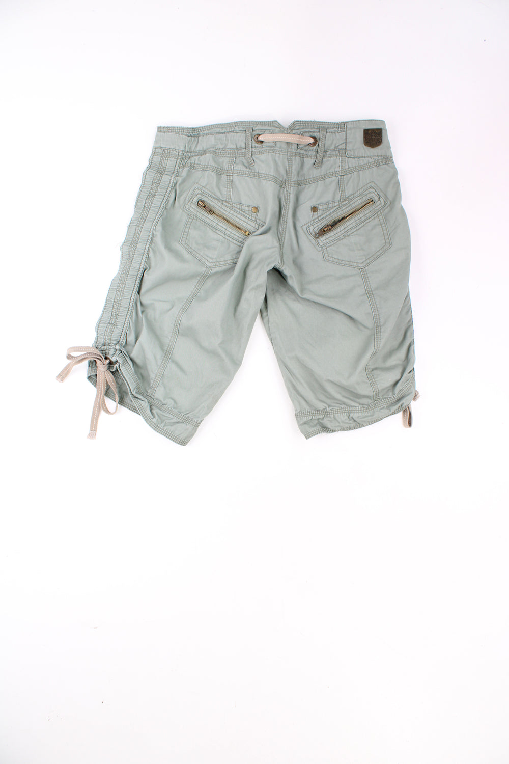 Y2K green capri shorts from River Island. Features ties on the sides of the leg to adjust the length  good condition  Size in Label: Womens size 8 (M)