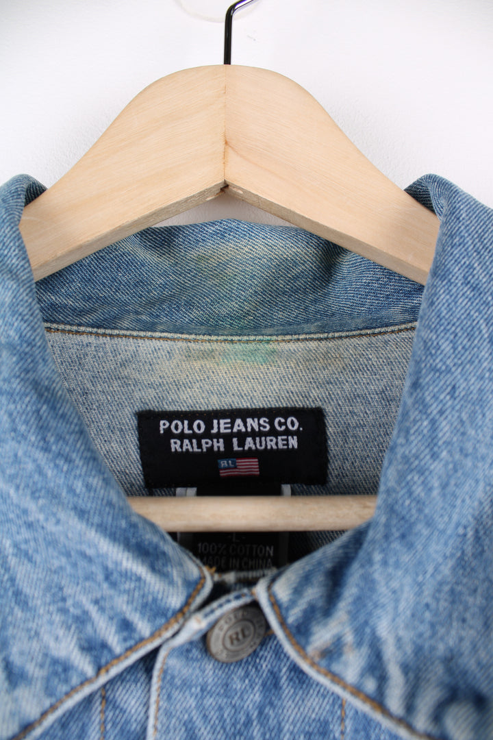 90's Polo Jeans by Ralph Lauren, cropped denim trucker jacket. Features embroidered flag on the back and double pockets