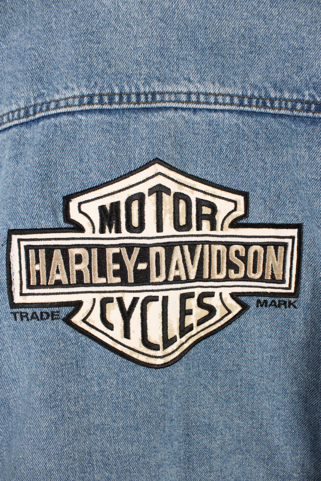 Vintage 90's Harley Davidson blue denim jacket, button up with multiple pockets and has big embroidered logo on the back.