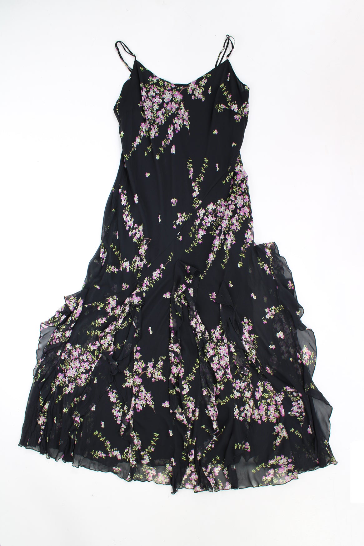 Y2K maxi dress features waterfall ruffled hem, made from a black floral outer layer with black layer underneath. 