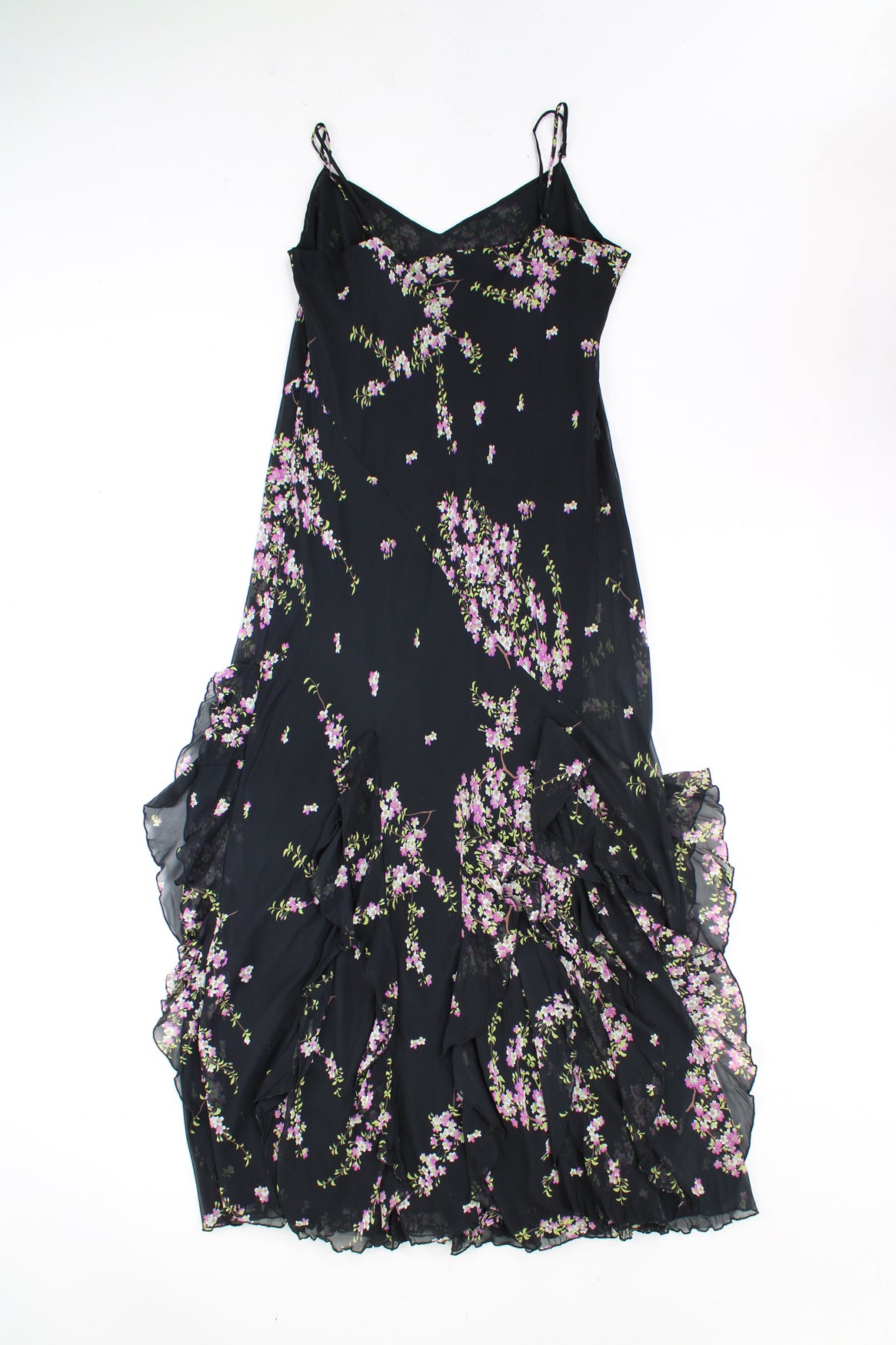 Y2K maxi dress features waterfall ruffled hem, made from a black floral outer layer with black layer underneath. 