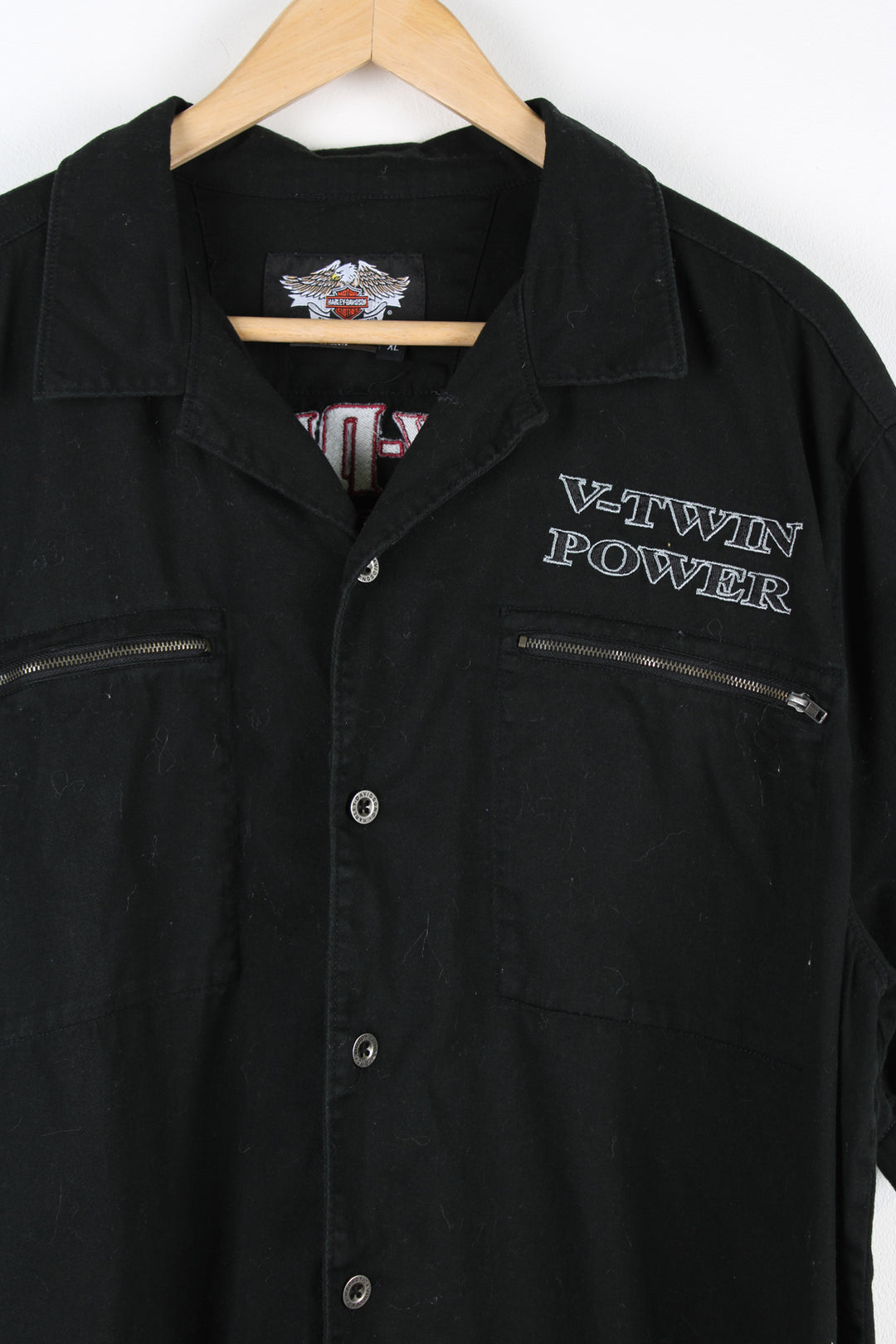 Vintage Harley Davidson Motorcycles short sleeve shirt in black, button up with a camp collar, double chest pockets, V-Twin Power embroidered on the front, and logo embroidered on the back. 