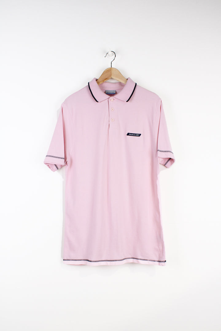 Vintage Reebok pink polo shirt with embroidered logo on the chest good condition Size in Label: Mens M - Measures slightly smaller like a S 