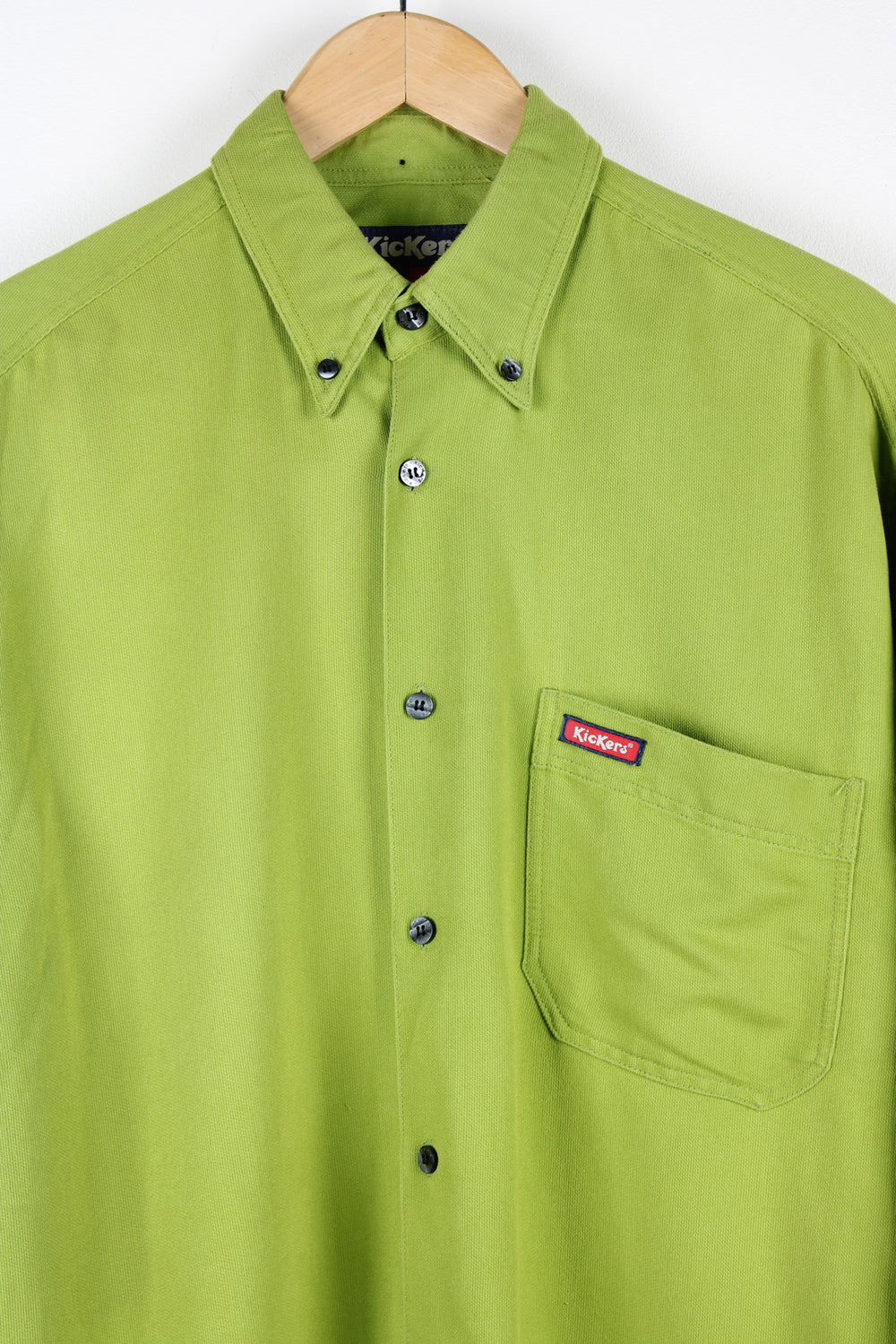 Kickers bright green button up shirt, features embroidered logo on pocket and dagger collar