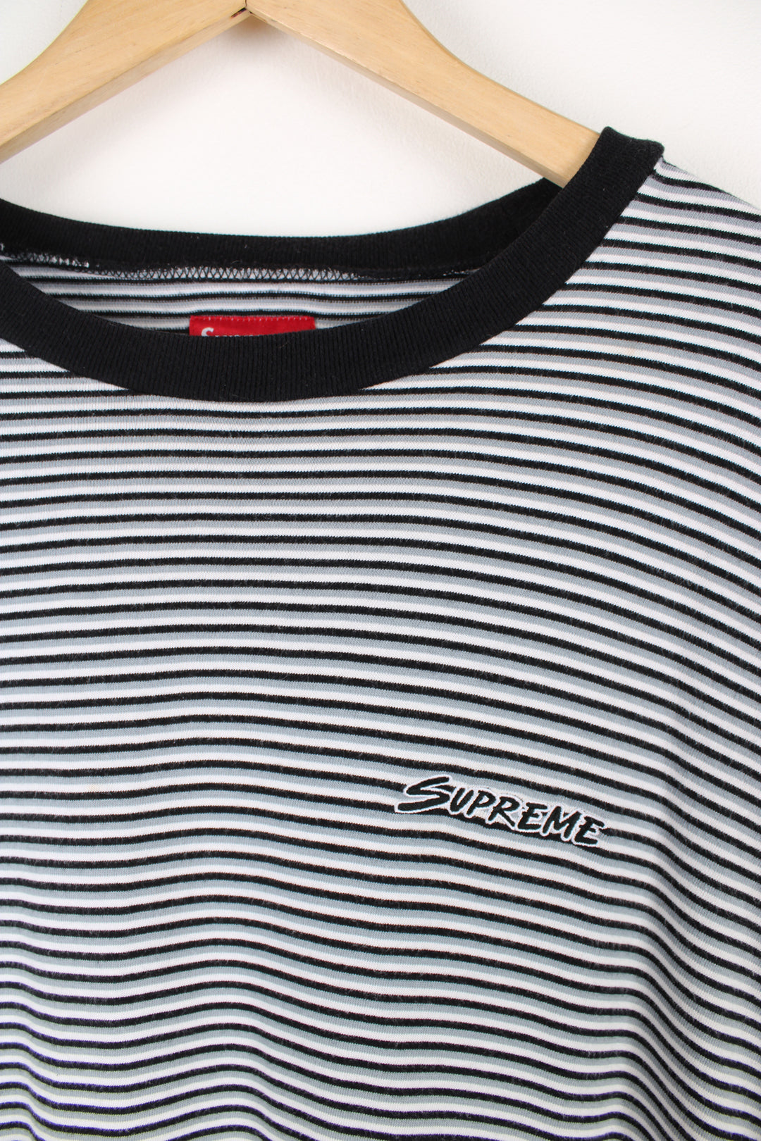 Supreme black, white and grey striped t-shirt, features embroidered spell-out on the chest