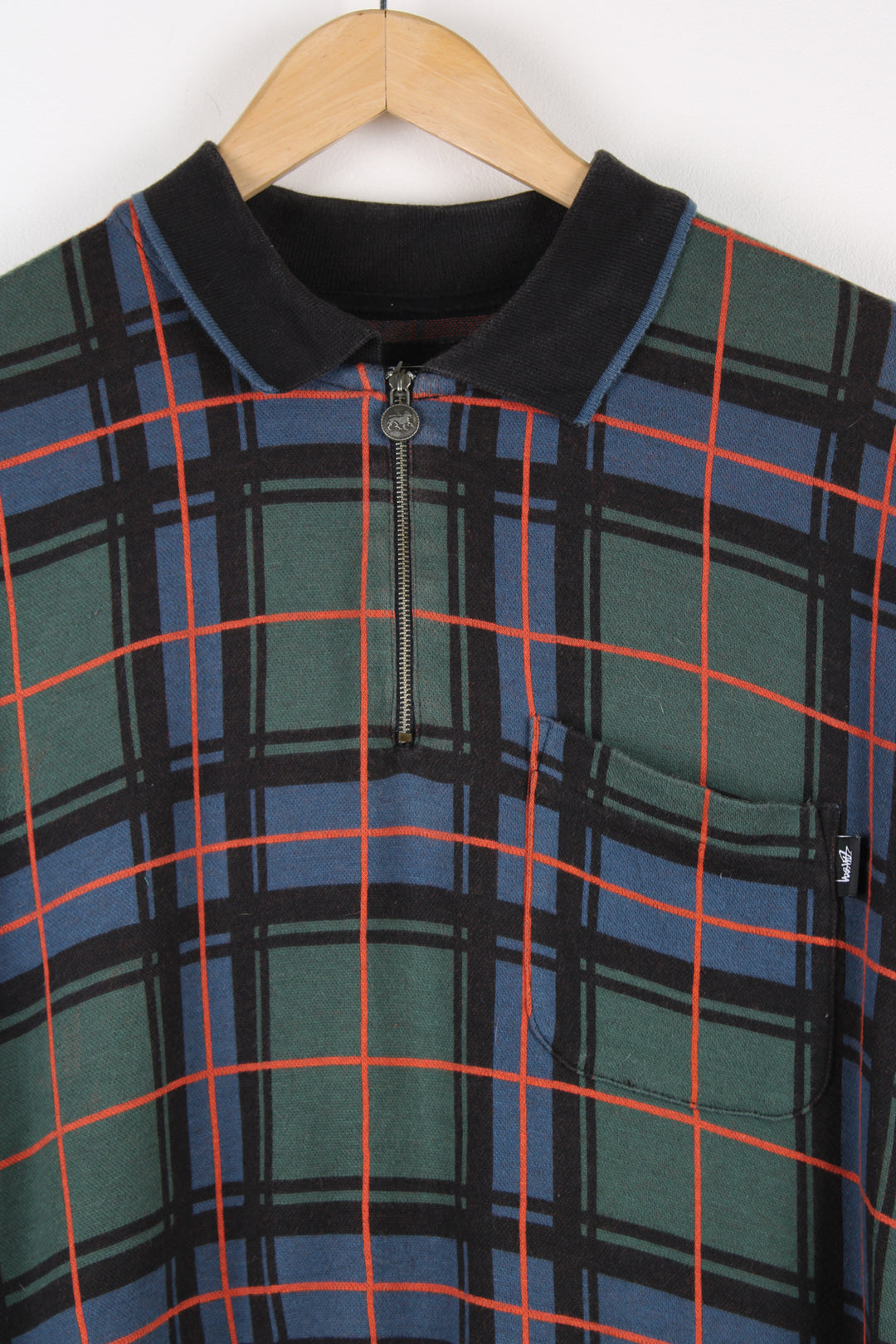 Stussy green and blue plaid polo shirt, features 1/4 zip and branded tab on the single chest pocket