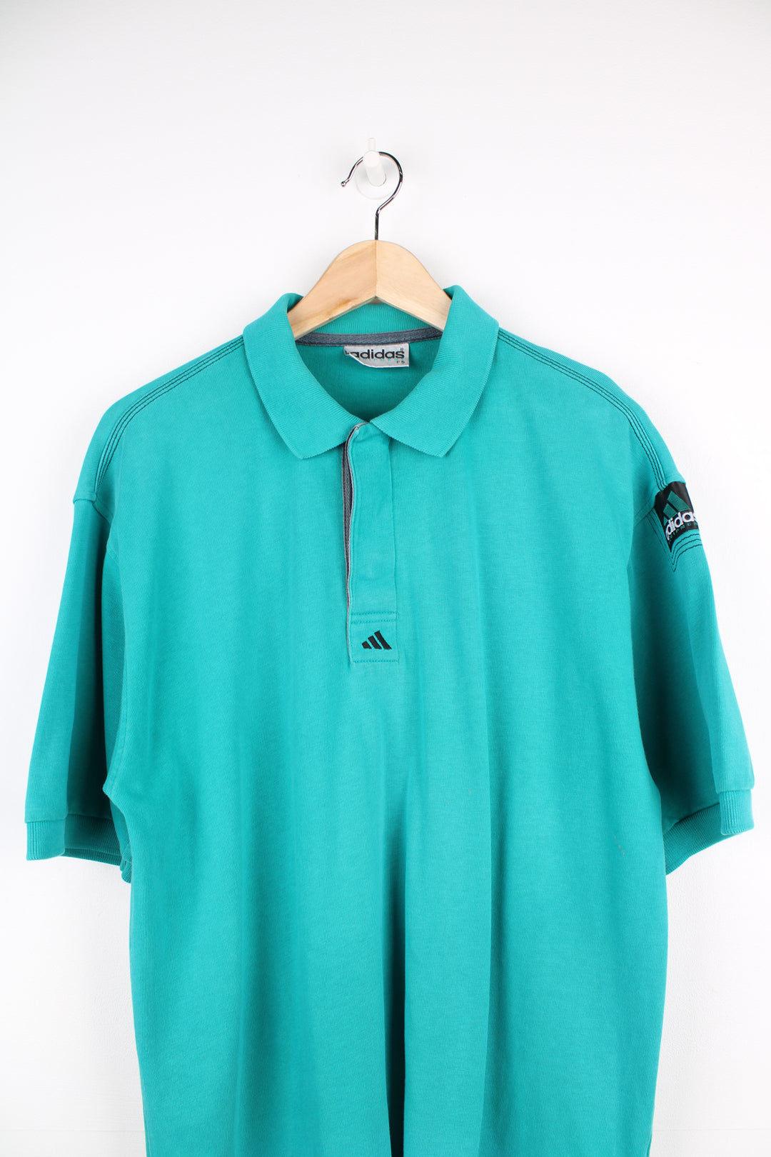 Vintage Adidas Equipment turquoise polo shirt with small embroidered logo on the chest and patch logo on the arm. good condition Size in Label: 42/ 44 - Measures like a mens L