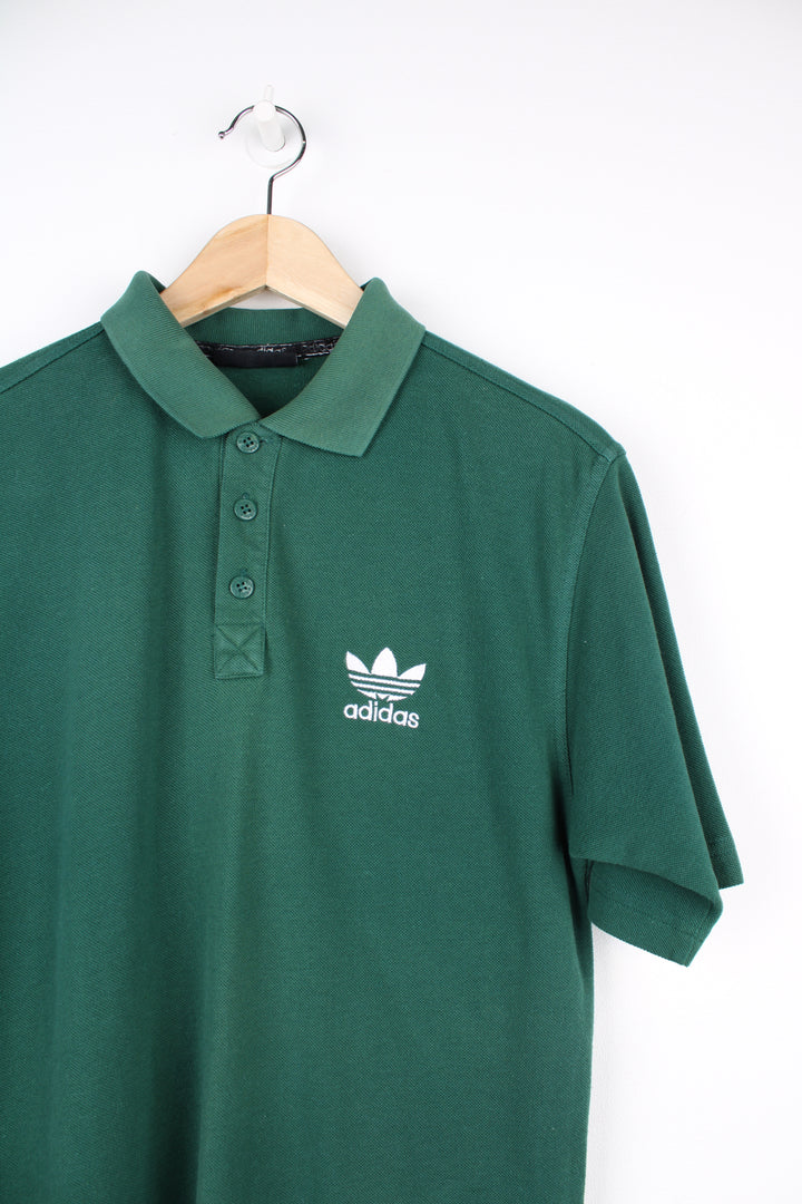 Vintage Adidas green polo shirt with embroidered logo on the chest. good condition Size in Label: 38/ 40 - Measures like a mens S