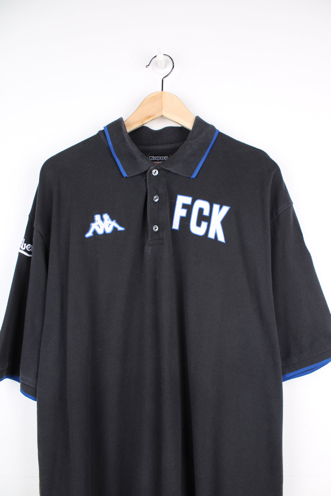 Vintage Kappa black polo shirt with embroidered Kappa logo on the chest and printed FCUK logo on the chest. Also features embroidered F.C. Københaven logo on one sleeve and Carlsberg logo on the other good condition Size in Label: Mens XXXLarge