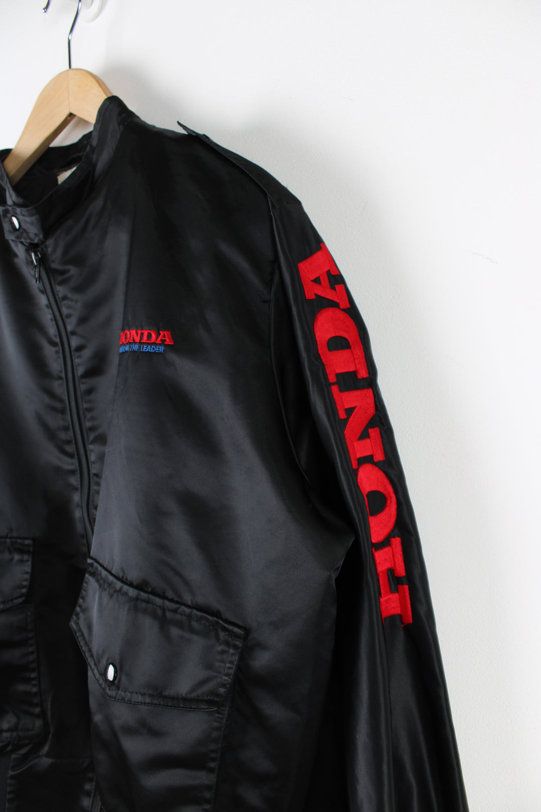 Vintage 1980's Honda black satin bomber jacket features embroidered spell-out details on the chest and down the sleeve 