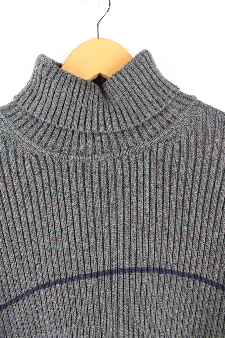 Tommy Hilfiger grey rib knit roll neck jumper. Features a horizontal darker grey stripe across the chest and embroidered logo on the hem. Made from a 100% cotton. good condition  Size in Label:  XL - Measures like a Mens M