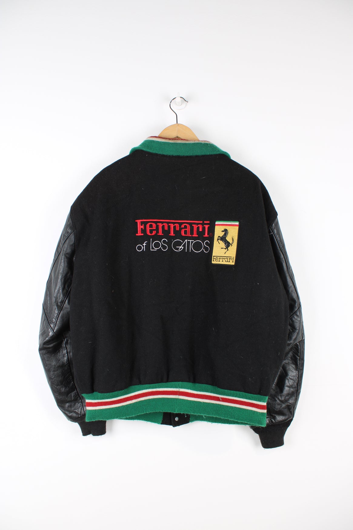 Vintage Ferrari themed black wool varsity jacket by Delong features embroidered badges on the chest and spell-out details across the back