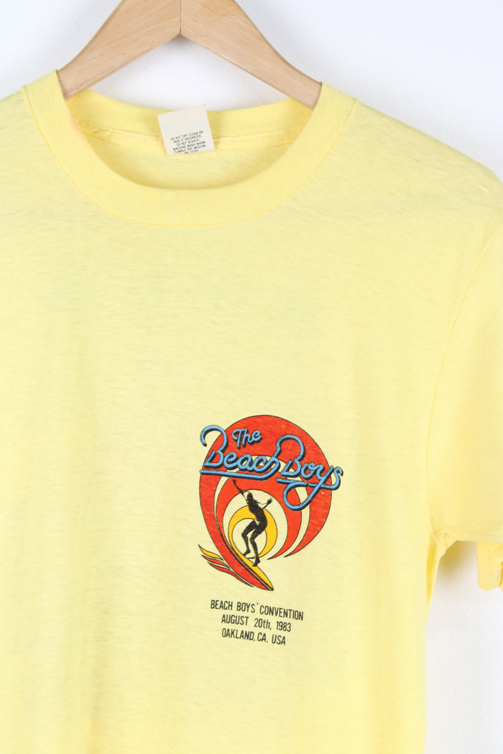 Vintage 1983 yellow Beach Boys convention t-shirt. Single stitch with design on the front and back.  good condition  Size in Label:  Slim fit M