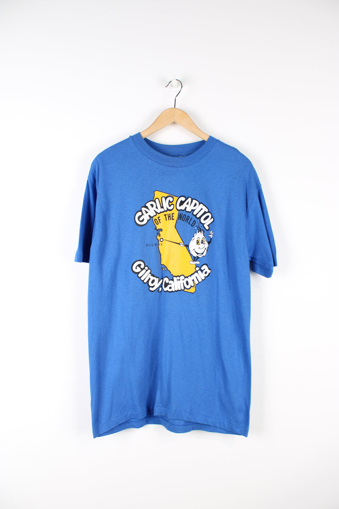 Vintage blue single stitch t-shirt with Gillroy California "Garlic capitol of the world" graphic on the front.  good condition  Size in Label:  Size L - Measures more like a Mens M