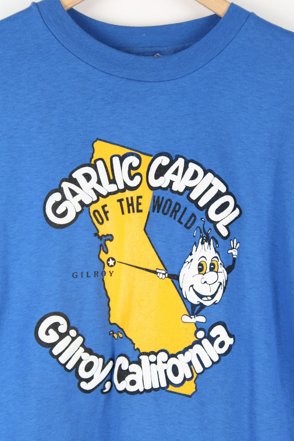 Vintage blue single stitch t-shirt with Gillroy California "Garlic capitol of the world" graphic on the front.  good condition  Size in Label:  Size L - Measures more like a Mens M