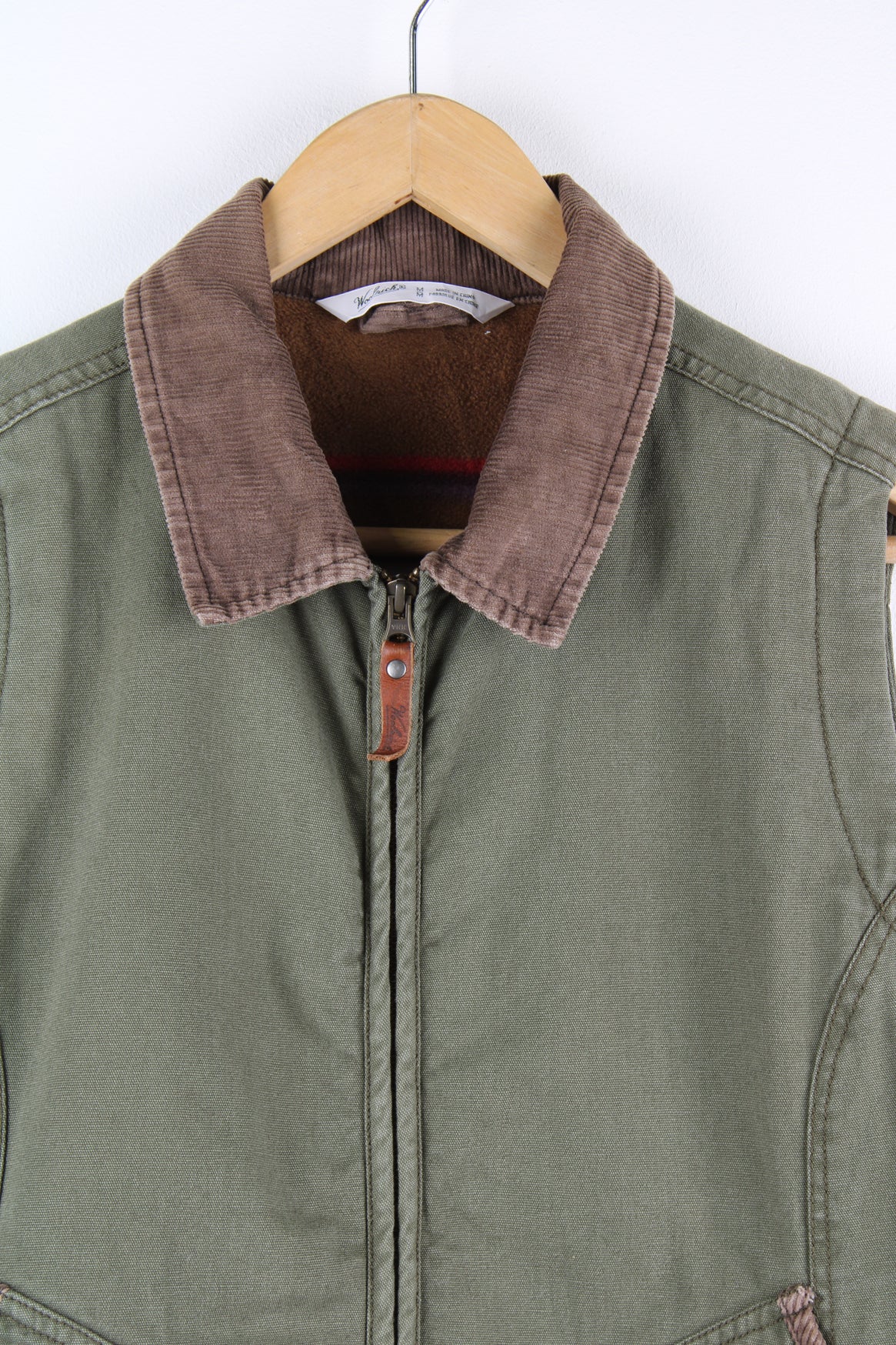 Forest green heavy duty cotton Woolrich workwear gilet, features striped fleece lining and corduroy collar