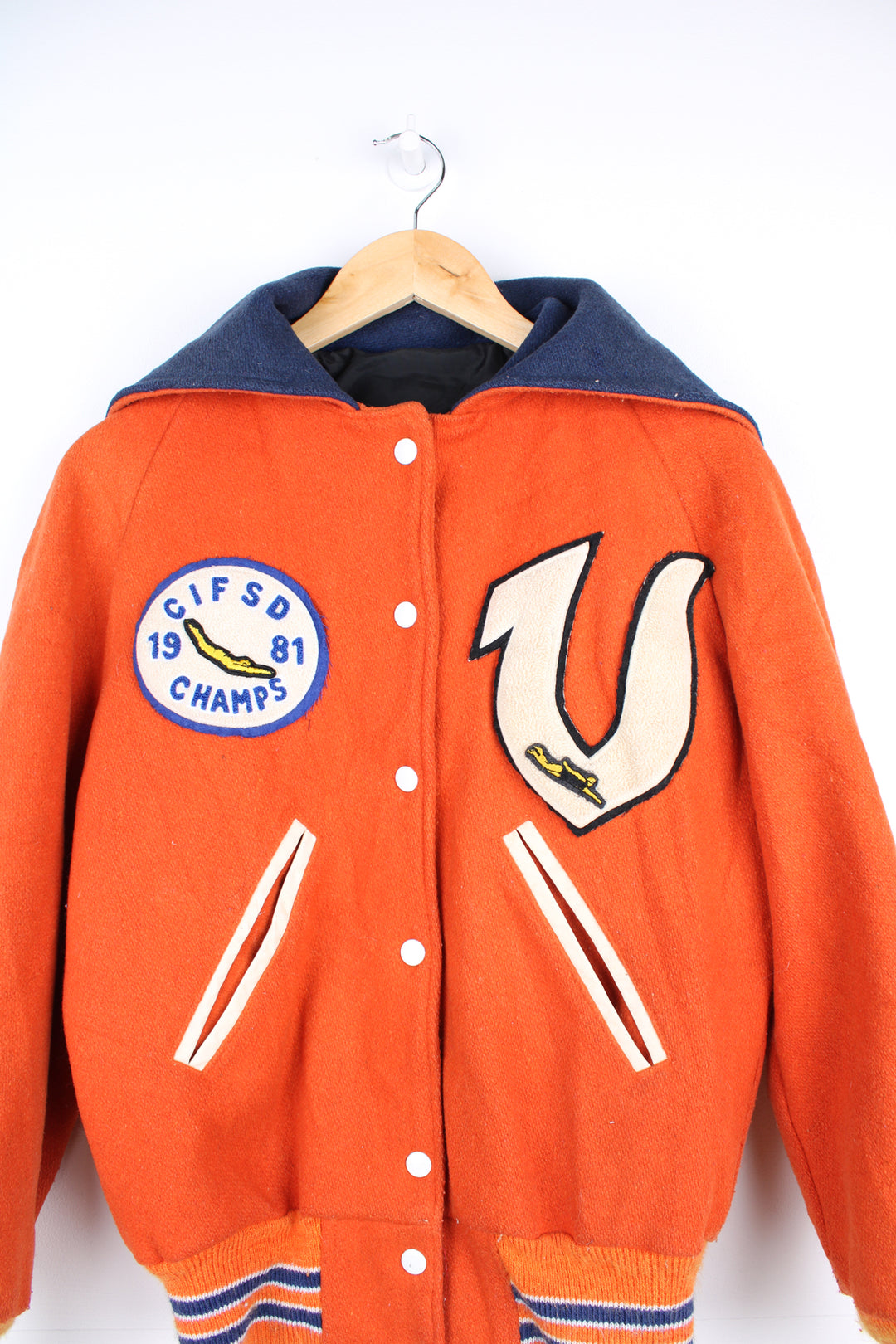 Vintage 1980s diving themed orange wool varsity jacket by Admiral Sportswear features leather sleeves and embroidered badges 