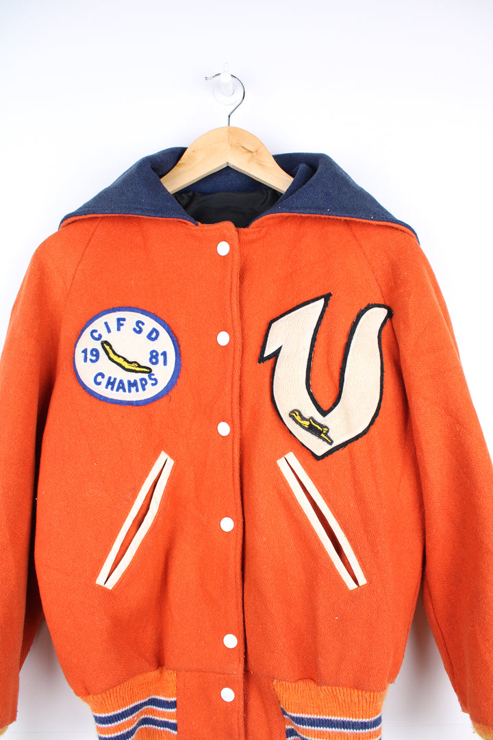 Vintage 1980s diving themed orange wool varsity jacket by Admiral Sportswear features leather sleeves and embroidered badges 