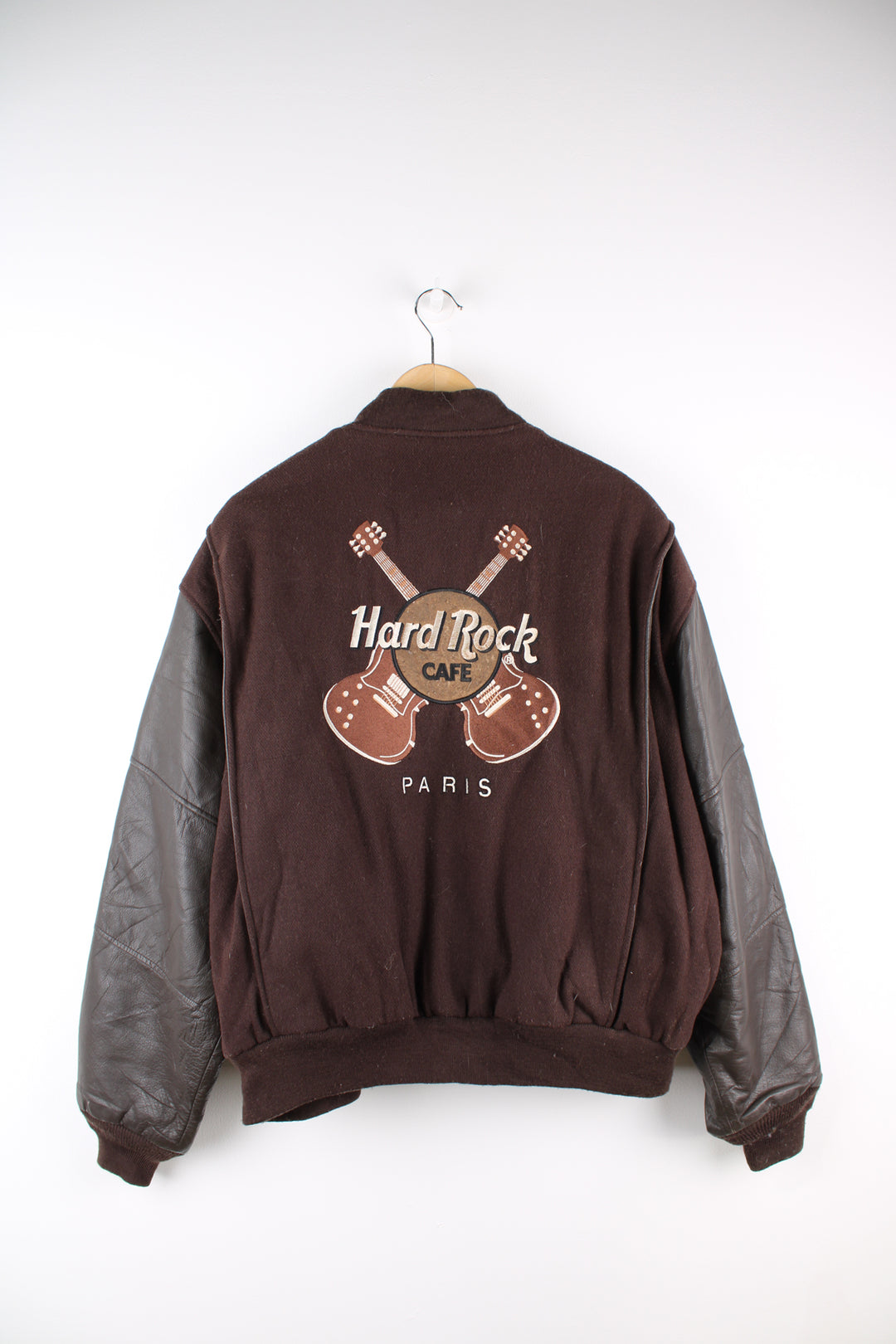 Vintage brown Hard Rock Hotel Paris varsity jacket with brown leather sleeves and embroidered badges on the front and back