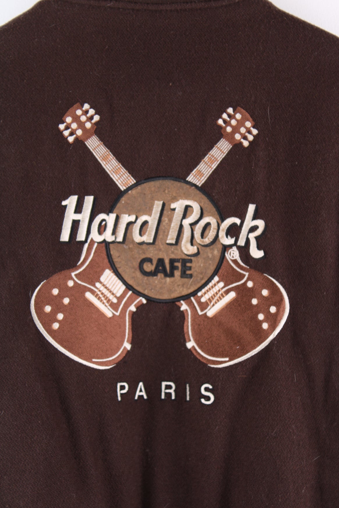 Vintage brown Hard Rock Hotel Paris varsity jacket with brown leather sleeves and embroidered badges on the front and back