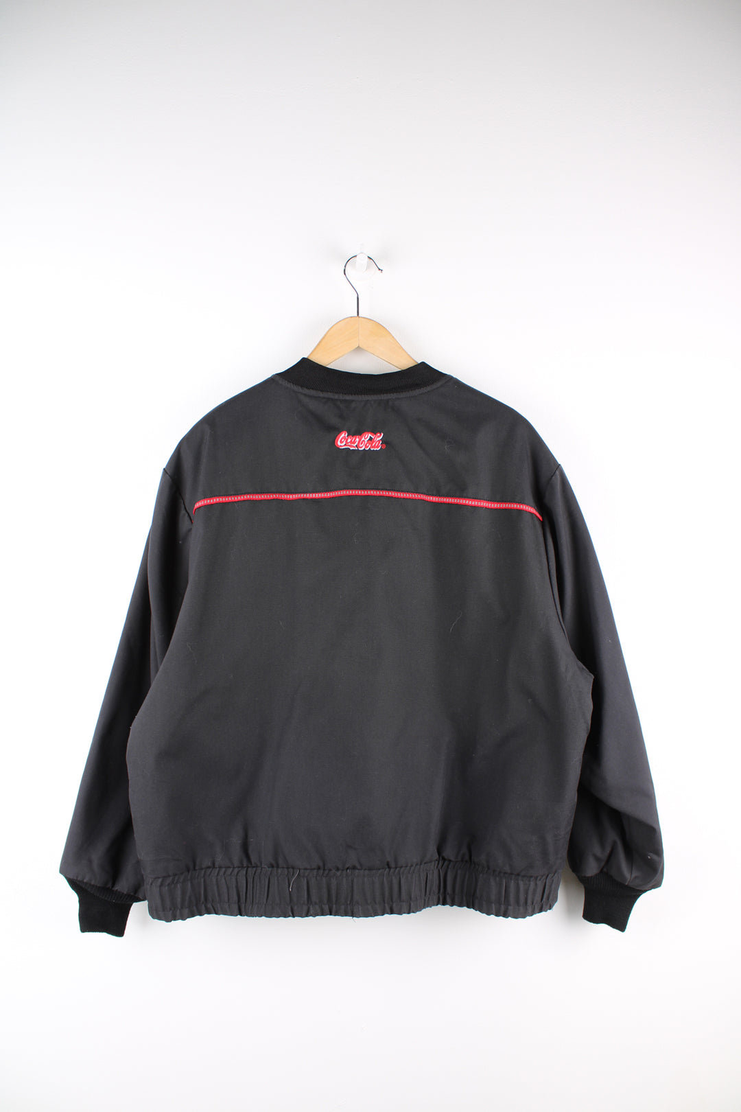 Coca Cola employee black zip through bomber jacket, features embroidered logo on the chest and back of shoulders