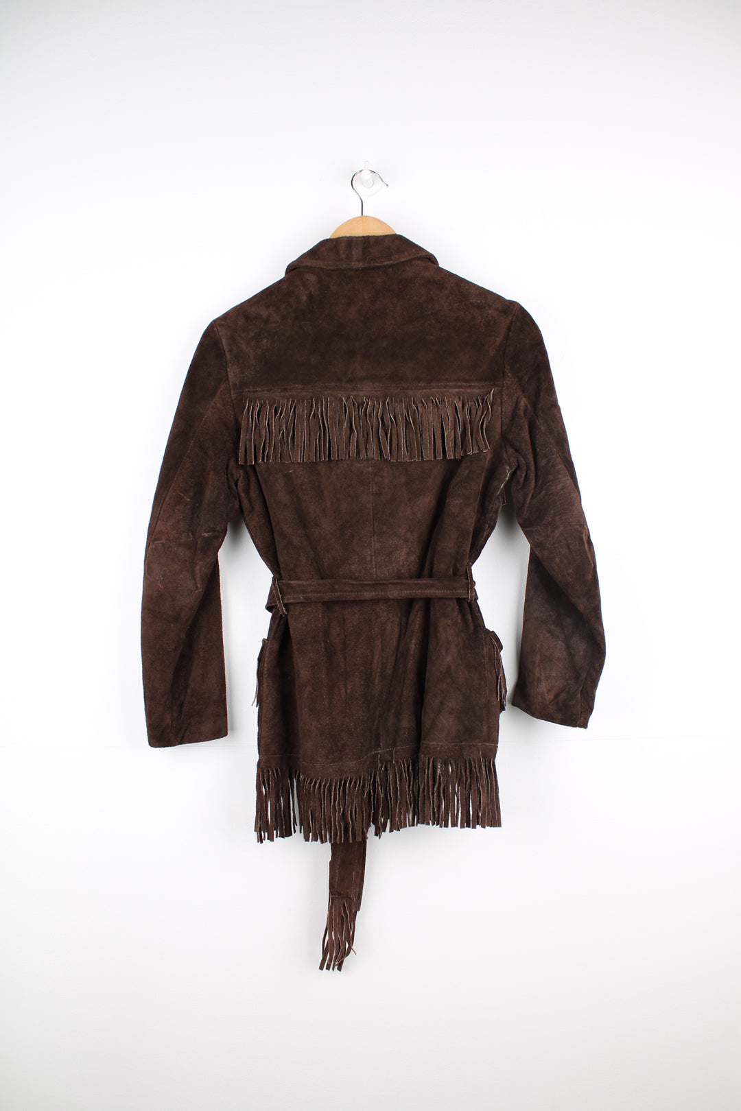 Vintage 1970s western style chocolate brown suede  jacket. Features belt, fringe detailing across the shoulders and down the sleeves and buttons for closure