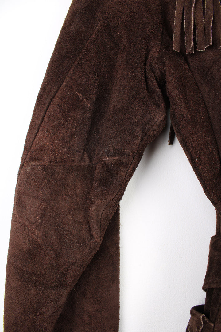 Vintage 1970s western style chocolate brown suede  jacket. Features belt, fringe detailing across the shoulders and down the sleeves and buttons for closure